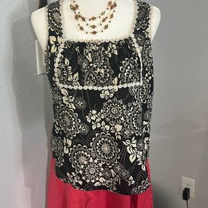 Moe. Darling black and beige floral print top. Lined with daisy lace.